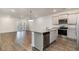 Modern kitchen with island, stainless steel appliances, and hardwood floors at 192 Sea Shell Dr. # 22, Murrells Inlet, SC 29576