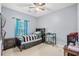 Comfortable bedroom with a ceiling fan, a large window, and neutral carpet and walls at 2060 Cross Gate Blvd. # 204, Surfside Beach, SC 29575