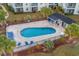 Aerial view of the beautiful community pool and lounge area surrounded by lush landscaping at 2060 Cross Gate Blvd. # 204, Surfside Beach, SC 29575