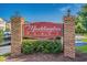 Community entrance sign for Maddington Place with brick columns and mature landscaping at 2060 Cross Gate Blvd. # 204, Surfside Beach, SC 29575