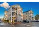 Exterior of condo building featuring screened in porches, light siding, and red shutters at 2060 Cross Gate Blvd. # 204, Surfside Beach, SC 29575