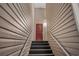 Exterior shot of the stairs leading up to a red condo front door, number 214 at 2060 Cross Gate Blvd. # 204, Surfside Beach, SC 29575