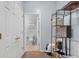 Hallway with an open door to a bathroom and a rack of storage and supplies at 2060 Cross Gate Blvd. # 204, Surfside Beach, SC 29575
