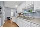 Efficient kitchen with white cabinets, neutral countertops, and modern sink at 2060 Cross Gate Blvd. # 204, Surfside Beach, SC 29575