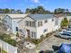 Aerial view of a tan three-story house with surrounding houses and cars at 2402 Hillside Dr. S, North Myrtle Beach, SC 29582