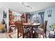 Bright dining area with wooden table and chairs, near kitchen and access to patio at 2402 Hillside Dr. S, North Myrtle Beach, SC 29582