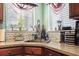 Corner kitchen sink with granite countertops and tile backsplash at 2402 Hillside Dr. S, North Myrtle Beach, SC 29582