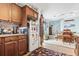 Kitchen with white appliances, wood cabinets, and view into dining area at 2402 Hillside Dr. S, North Myrtle Beach, SC 29582