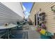 Private patio with seating area and storage shelving at 2402 Hillside Dr. S, North Myrtle Beach, SC 29582