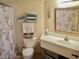 Fresh bathroom offering organized storage and a shower curtain with subtle, organic patterning at 2504 Ocean Blvd. N # 232, Myrtle Beach, SC 29577