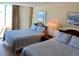 Well-lit bedroom features two beds with matching decor, providing a cozy retreat at 2504 Ocean Blvd. N # 232, Myrtle Beach, SC 29577