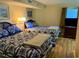 Cozy bedroom offering two beds with warm lighting, creating a relaxing atmosphere at 2504 Ocean Blvd. N # 232, Myrtle Beach, SC 29577