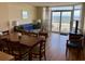 Cozy living room featuring comfortable seating, dining area, and balcony access with beautiful ocean views at 2504 Ocean Blvd. N # 232, Myrtle Beach, SC 29577