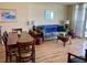 Inviting living room features cozy seating, complemented by warm wood floors and beach artwork at 2504 Ocean Blvd. N # 232, Myrtle Beach, SC 29577