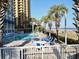 Resort-style pool with beach access, lounge chairs, and palm trees at 2504 Ocean Blvd. N # 232, Myrtle Beach, SC 29577