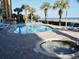 Inviting pool area with a hot tub, lounge chairs, and views of the surrounding landscape at 2504 Ocean Blvd. N # 232, Myrtle Beach, SC 29577