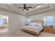 Main bedroom with tray ceiling, large bed, and en-suite bathroom at 317 Welcome Dr., Myrtle Beach, SC 29579