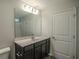 Bathroom showcasing a large mirror, vanity with dark cabinets, and a shower/tub combo at 399 Lifestyle Court, Surfside Beach, SC 29575