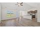 Open-concept space with vaulted ceiling, wood-look floors, lots of natural light, and modern appliances at 399 Lifestyle Court, Surfside Beach, SC 29575