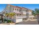 Three-story building with multiple units, each featuring private balconies and garages at 400 Hillside Dr. N # 302C, North Myrtle Beach, SC 29582