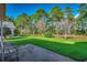 Spacious backyard with vibrant green grass, mature trees, and a peaceful wooded backdrop at 4382 Saint Annes Ct., Myrtle Beach, SC 29579