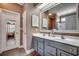 Bathroom with double sinks, gray vanity, and a large mirror at 4382 Saint Annes Ct., Myrtle Beach, SC 29579