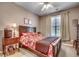 Bedroom features a wooden bed frame, floral bedding, window with curtains and a ceiling fan at 4382 Saint Annes Ct., Myrtle Beach, SC 29579
