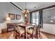 Cozy dining room with a chandelier and wooden table set for six, perfect for Gathering dinners at 4382 Saint Annes Ct., Myrtle Beach, SC 29579