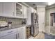 Well-lit kitchen features white cabinets, stainless steel appliances, granite countertops, and a beverage cooler at 4382 Saint Annes Ct., Myrtle Beach, SC 29579