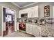 Bright kitchen features granite countertops, stainless steel appliances, and white cabinets at 4382 Saint Annes Ct., Myrtle Beach, SC 29579