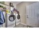 A laundry room equipped with a washer, a dryer, and shelving for storage at 4382 Saint Annes Ct., Myrtle Beach, SC 29579
