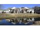 Condominium with a pond view, palm trees, a green space and a reflection at 4657 Fringetree Dr. # C, Murrells Inlet, SC 29576