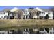 Beautiful two-story home with brick facade, lots of windows, and reflected in a pond at 4657 Fringetree Dr. # C, Murrells Inlet, SC 29576