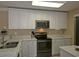 Modern kitchen featuring white cabinets, stainless steel appliances, and bright marble countertops at 4657 Fringetree Dr. # C, Murrells Inlet, SC 29576
