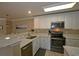Stylish kitchen features white cabinets, marble countertops, stainless steel appliances, and a bar area at 4657 Fringetree Dr. # C, Murrells Inlet, SC 29576