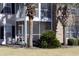 Screened patio with palm trees, a sitting area and view of the yard at 4657 Fringetree Dr. # C, Murrells Inlet, SC 29576