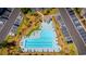 Aerial view of a large, uniquely shaped pool surrounded by seating, landscaping, and a parking lot at 4657 Fringetree Dr. # C, Murrells Inlet, SC 29576