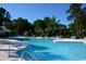 Inviting swimming pool with clear blue water, sun loungers, and umbrellas for relaxing poolside at 4657 Fringetree Dr. # C, Murrells Inlet, SC 29576