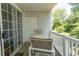 Small balcony with outdoor seating and wooded views at 5801 Oyster Catcher Dr. # 1624, North Myrtle Beach, SC 29582