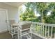 Private balcony with table and chairs, overlooking trees at 5801 Oyster Catcher Dr. # 1624, North Myrtle Beach, SC 29582
