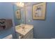 Light blue bathroom with vanity, mirror, and framed art at 5801 Oyster Catcher Dr. # 1624, North Myrtle Beach, SC 29582