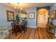 Elegant dining area with hardwood floors and a charming chandelier at 5801 Oyster Catcher Dr. # 1624, North Myrtle Beach, SC 29582