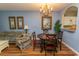 Elegant dining area with hardwood floors and a charming chandelier at 5801 Oyster Catcher Dr. # 1624, North Myrtle Beach, SC 29582