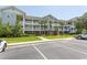 Attractive three-story building with ample parking and lush landscaping at 5801 Oyster Catcher Dr. # 1624, North Myrtle Beach, SC 29582