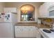 Well-equipped kitchen featuring white cabinets, granite countertops, and modern appliances at 5801 Oyster Catcher Dr. # 1624, North Myrtle Beach, SC 29582