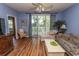 Relaxing living room with hardwood floors, access to a balcony, and plenty of natural light at 5801 Oyster Catcher Dr. # 1624, North Myrtle Beach, SC 29582