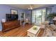 Bright living room with hardwood floors, comfy seating, and access to a private balcony at 5801 Oyster Catcher Dr. # 1624, North Myrtle Beach, SC 29582