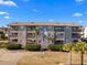 Two-story building with stone exterior and balconies at 612 S Ocean Blvd. # 301A, Surfside Beach, SC 29575