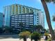 Oceanfront resort building with parking and palm trees at 6804 N Ocean Blvd. # 1527, Myrtle Beach, SC 29572