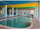 Relaxing indoor pool with colorful ceiling and lounge chairs at 6804 N Ocean Blvd. # 1527, Myrtle Beach, SC 29572